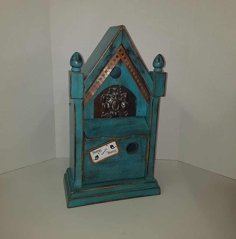 rustic birdhouse hand built from an antique steeple clock case