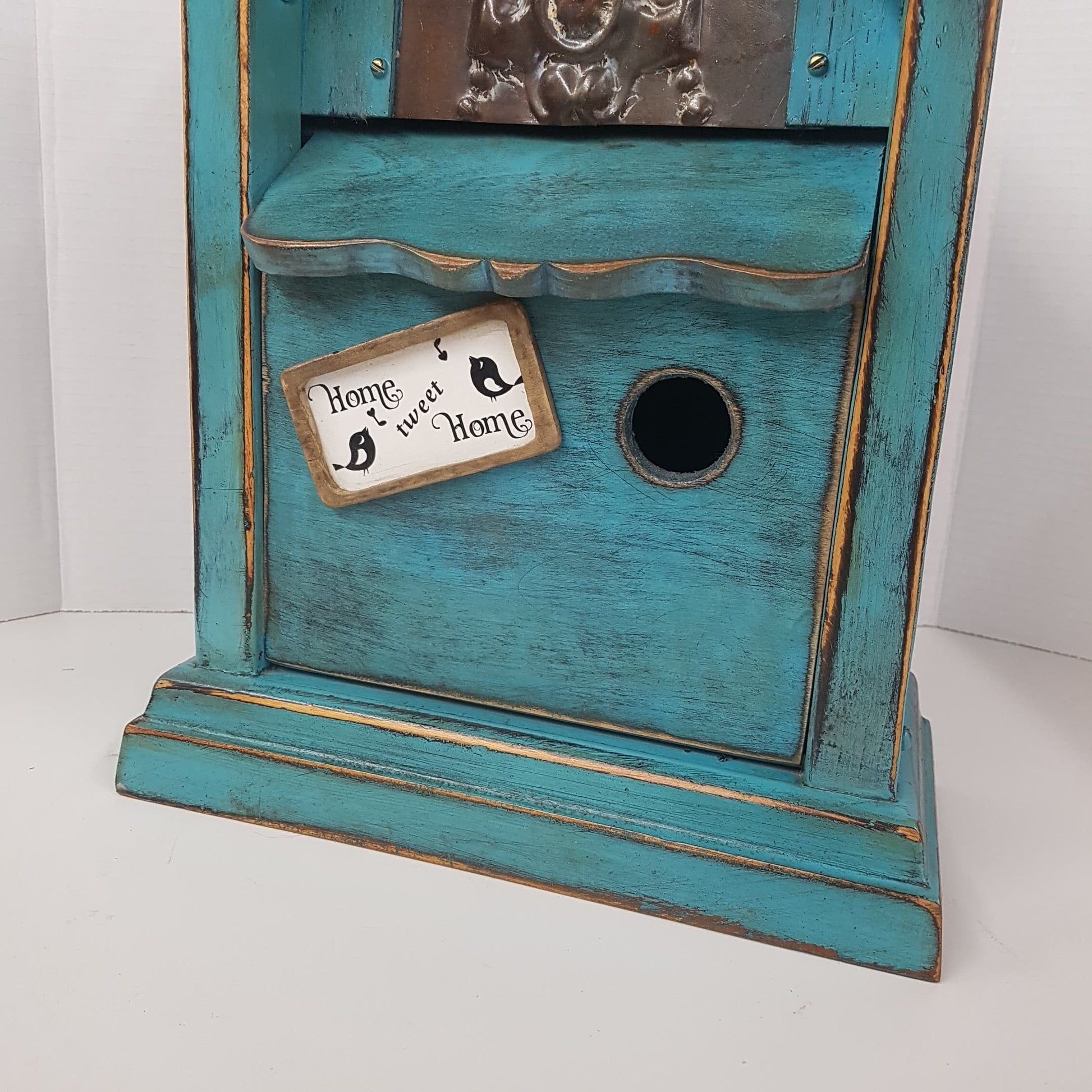 rustic birdhouse hand built from an antique steeple clock case