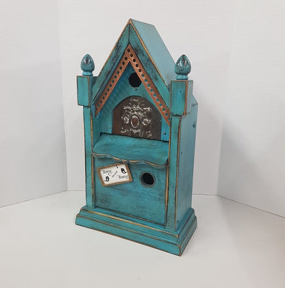 rustic birdhouse hand built from an antique steeple clock case
