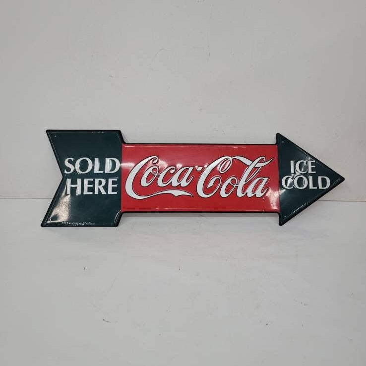 tin coca-cola sign arrow