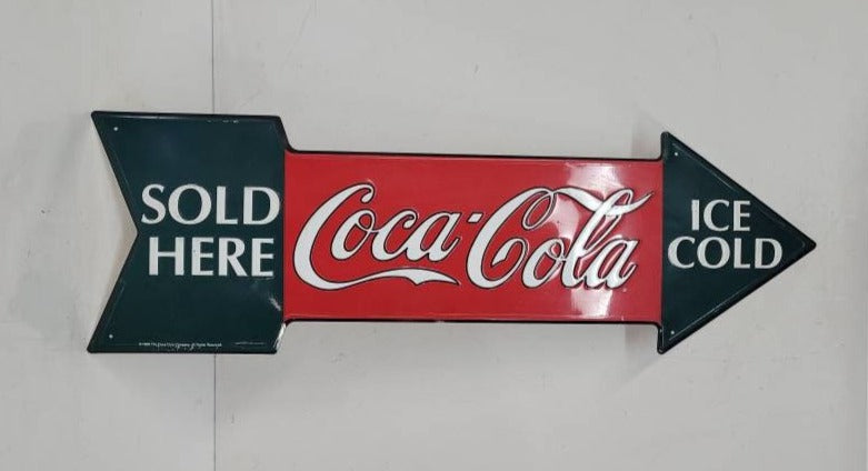tin coca-cola sign arrow