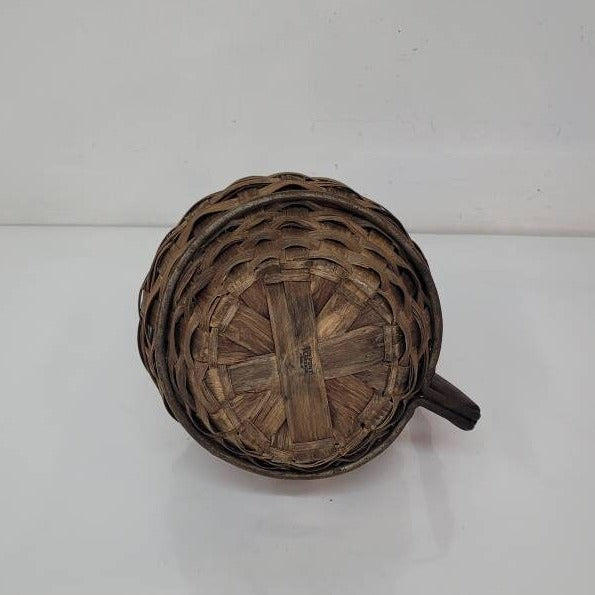 green glass wine bottle with wicker basket oudepont italy