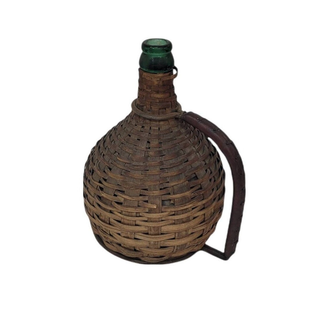 green glass wine bottle with wicker basket oudepont italy