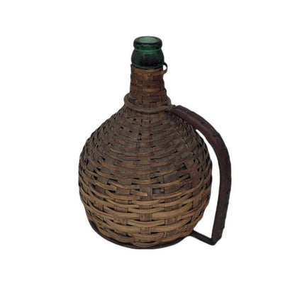 green glass wine bottle with wicker basket oudepont italy