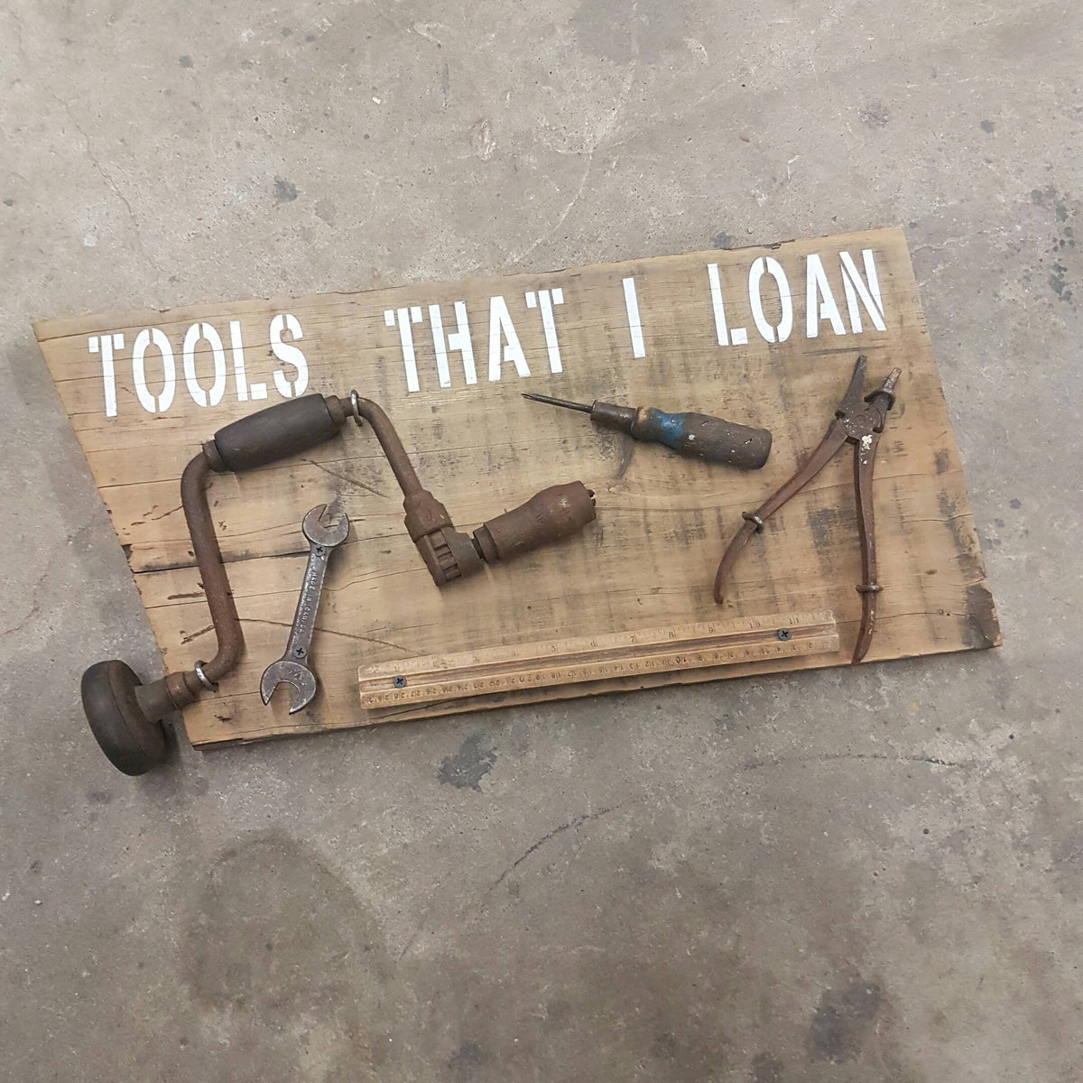  Handmade rustic Tools That I Loan garage sign with five useless tools
