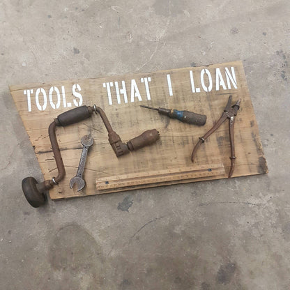  Handmade rustic Tools That I Loan garage sign with five useless tools
